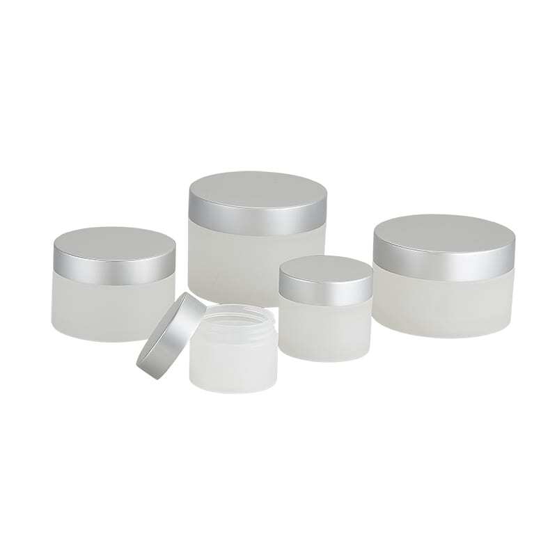 white cosmetic jars with brushed silver lids grouped together Model BLHBPPAL