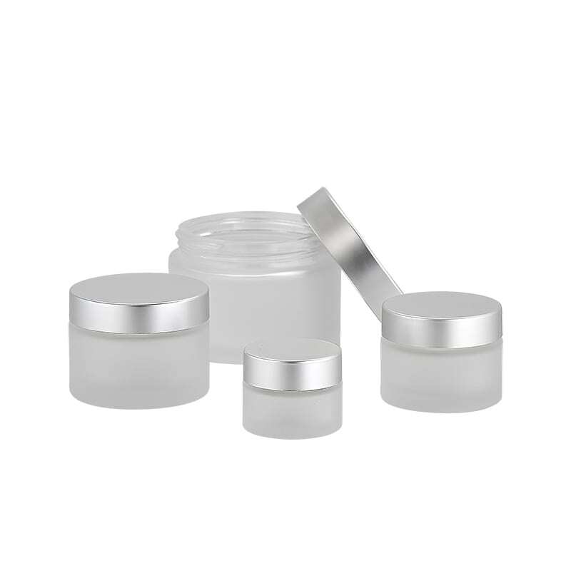 frosted glass cosmetic jars grouped together with lids Model BLSXJF